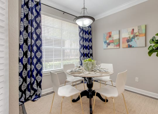 a dining room with a table and chairs
