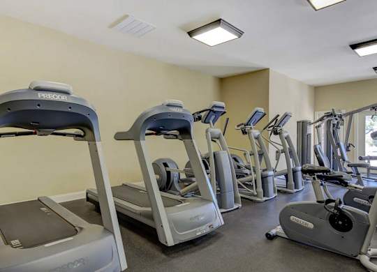 A gym with treadmills and elliptical machines at Ethan Pointe Apartments, Greensboro