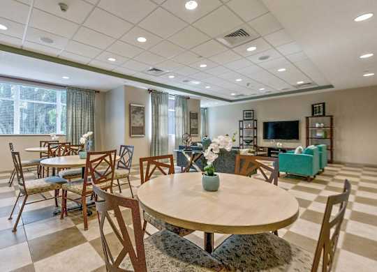 A dining room with a round table and chairs.