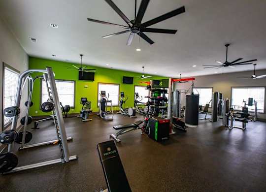 A gym with a variety of equipment including weights and cardio machines. at Foxwood Apartments, Raleigh-Durham, North Carolina