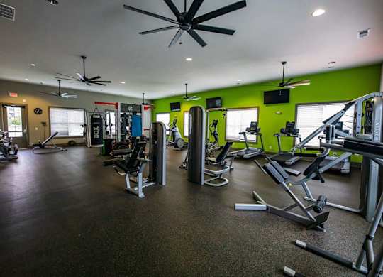 A gym with a variety of equipment including treadmills, weights, and exercise machines. at Foxwood Apartments, Raleigh-Durham, NC