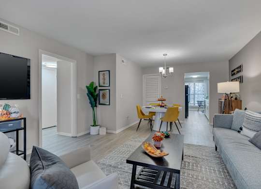 A living room with a grey couch and a yellow chair.