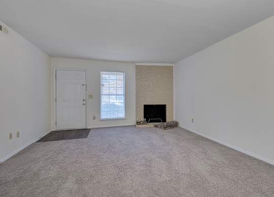 A room with a fireplace and a door.