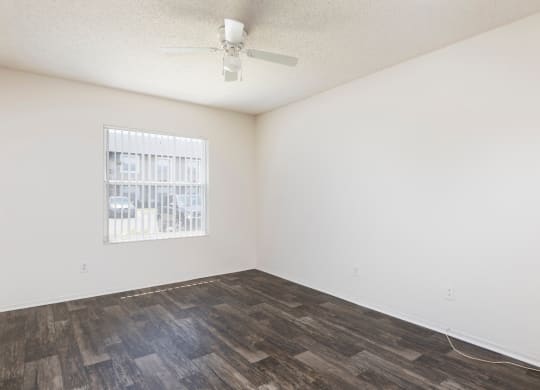 a bedroom with a bed and a ceiling fan