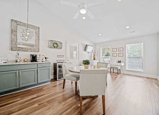 A modern kitchen with a dining table and chairs. at Brandemere Apartment Homes, Winston Salem