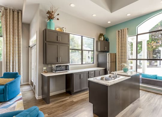 a kitchen with gray cabinets and a large window at Bridges at Mallard Creek Apartment Homes, Charlotte, NC