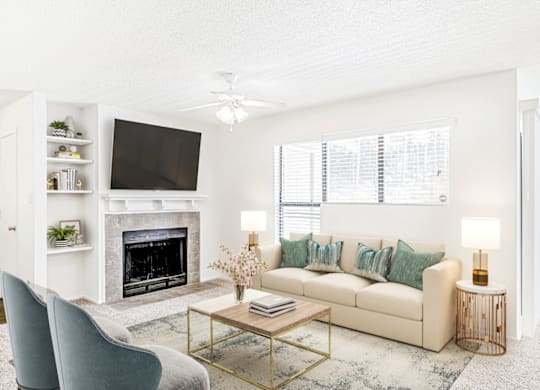 a living room with a fireplace and a tv  at Bridges at Mallard Creek Apartment Homes, Charlotte