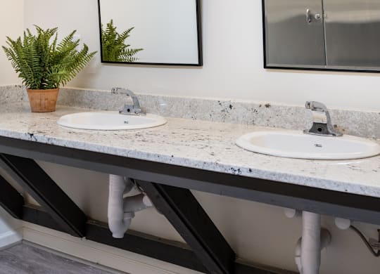 A Bathroom with two sinks and two mirrors at Bridges at Mallard Creek Apartment Homes, Charlotte, NC