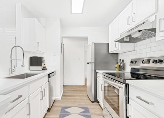 a kitchen with white cabinets and stainless steel appliances at Bridges at Mallard Creek Apartment Homes, Charlotte, NC, 28269
