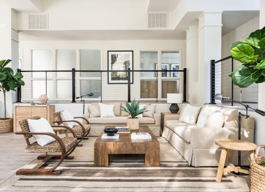 a living room filled with furniture and a large window at Bridges at Mallard Creek Apartment Homes, Charlotte
