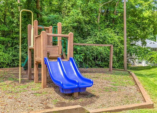 a playground with two slides at Bridges at Mallard Creek Apartment Homes, North Carolina, 28269