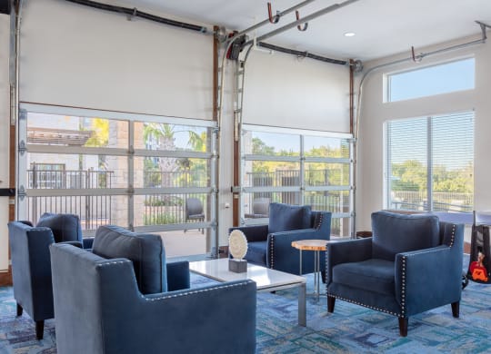 clubhouse with blue chairs and firehouse style garage doors