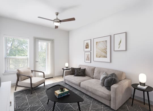 an image of a living room with a couch and windows
