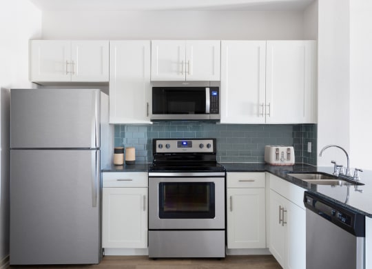 kitchen with stainless steel appliances and white cabinets