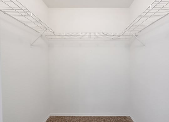 a small room with white walls and white shelves