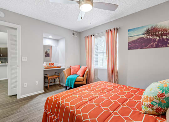 bedroom with ceiling fan and built-in desk area