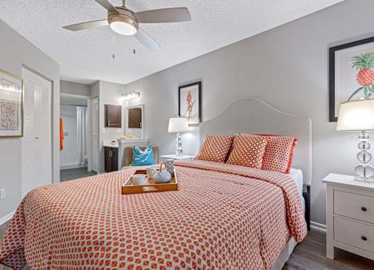 Bedroom with a bed, nightstand, and a ceiling fan.