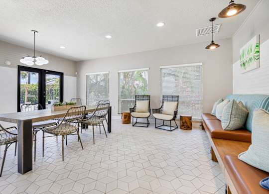 resident clubhouse with tables, chairs, and booths