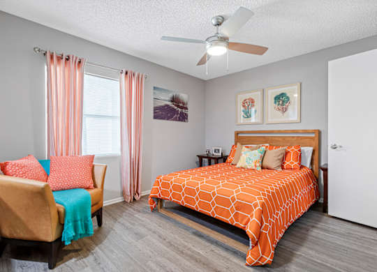bedroom with hardwood-style flooring and ceiling fan