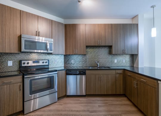 a kitchen with stainless steel appliances and wooden cabinets