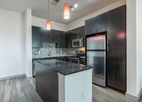 a kitchen with stainless steel appliances and a counter top
