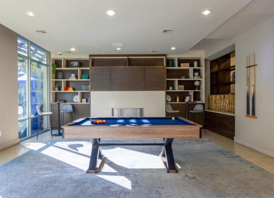 Resident clubhouse with pool table and book shelf