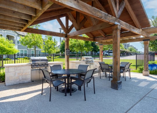 Poolside sitting area next to outdoor kitchen