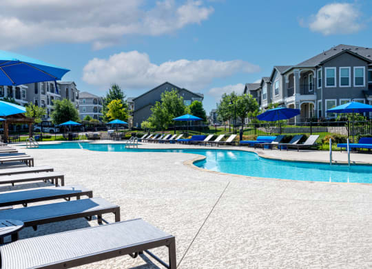 Lounge chairs on the sundeck next to swimming pool