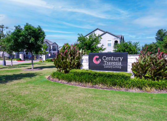 Property sign surrounded by bushes and greenery