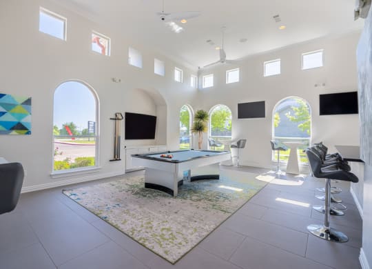 a game room with a pool table and television