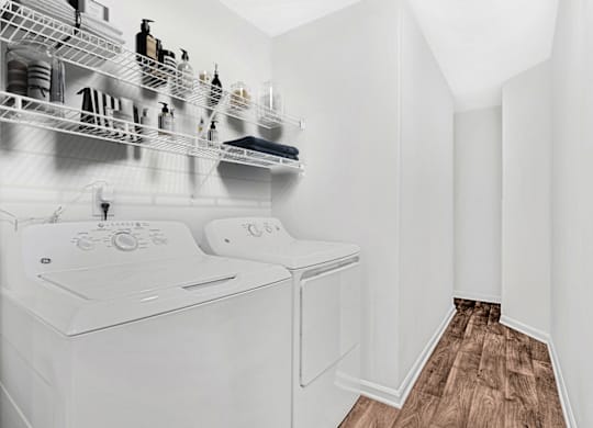 a washer and dryer in a laundry room at Caveness Farms Apartments, Wake Forest, NC 27587