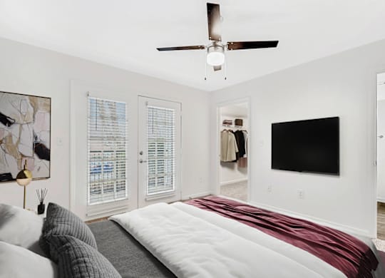 a bedroom with a bed and a ceiling fan at Caveness Farms Apartments, Wake Forest, NC 27587