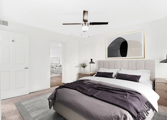 a bedroom with a bed and a ceiling fan at Caveness Farms Apartments, Wake Forest 
