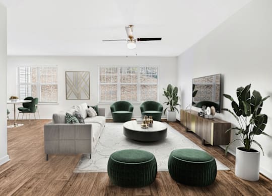 a living room with white walls and hardwood floors at Caveness Farms Apartments, Wake Forest 