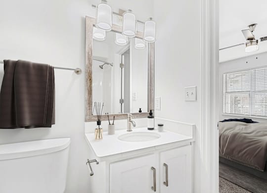 a small bathroom with a sink and a mirror at Caveness Farms Apartments, Wake Forest, 27587 