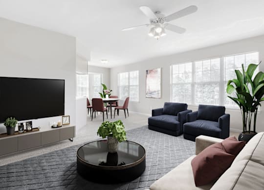a living room with white walls and a large tv on the wall at Caveness Farms Apartments, Wake Forest North Carolina 