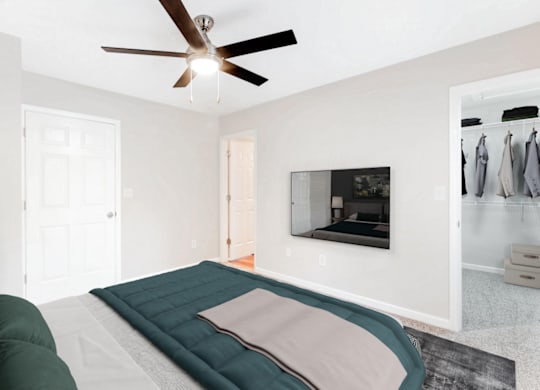 a bedroom with a bed and a ceiling fan at Caveness Farms Apartments, North Carolina, 27587