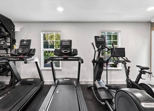 a gym with treadmills and exercise bikes at Caveness Farms Apartments, Wake Forest North Carolina 
