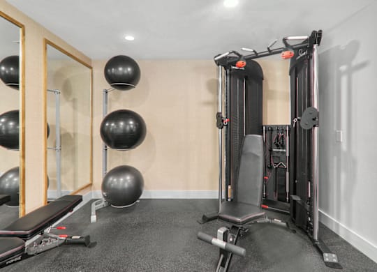 a home gym with exercise equipment and weights at Caveness Farms Apartments, Wake Forest, 27587 