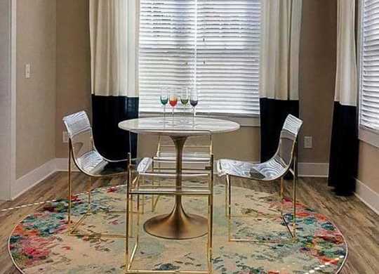 A dining room with a round table and chairs at Foxwood Apartments, Raleigh-Durham, NC