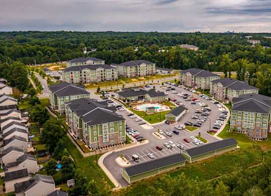 A large building complex surrounded by trees at Foxwood Apartments, Raleigh-Durham, NC