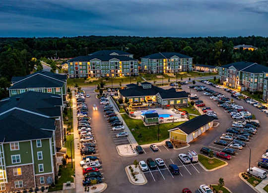 A parking lot is surrounded by apartment buildings. at Foxwood Apartments, North Carolina