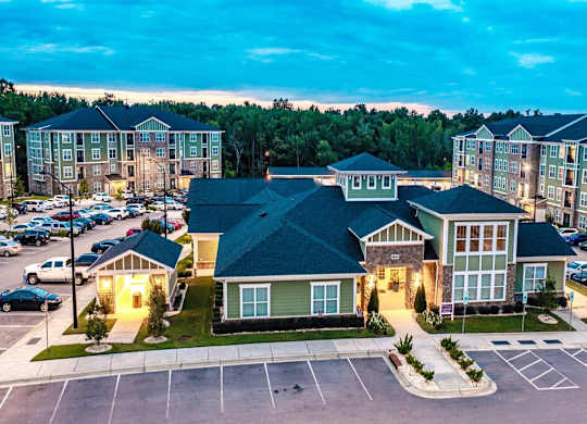 A parking lot in front of a building with a green roof at Foxwood Apartments, Raleigh-Durham, North Carolina