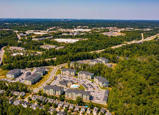 A bird's eye view of a residential area with apartment buildings and a road at Foxwood Apartments, Raleigh-Durham, North Carolina