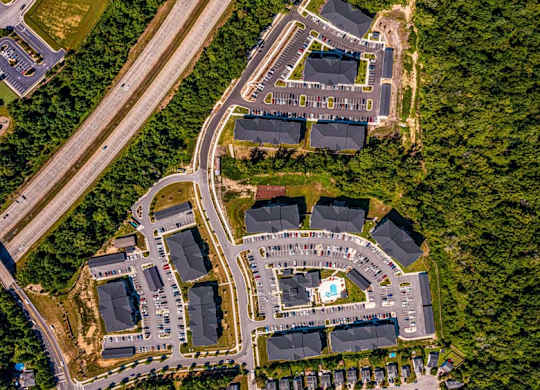 A bird's eye view of a residential area with a large building in the center at Foxwood Apartments, Raleigh-Durham