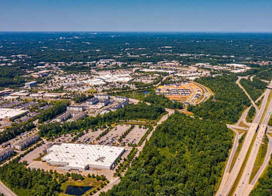 A highway interchange with a large white building to the left at Foxwood Apartments, North Carolina