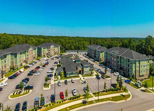 A large apartment complex with a parking lot in front at Foxwood Apartments, Raleigh-Durham, NC, 27616