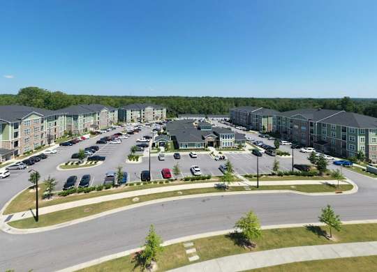 A large parking lot is surrounded by apartment buildings at Foxwood Apartments, Raleigh-Durham, NC