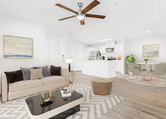 A living room with a beige couch, a coffee table, and a ceiling fan. at The Grayson Apartment Homes, Charlotte, 28262