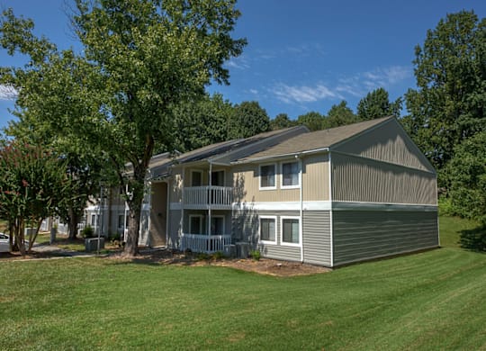 a home with a gray and white exterior and a large grassy yard at Eastchester Ridge Apartments, North Carolina, 27262